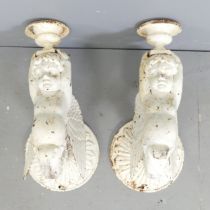 A pair of Victorian painted cast iron wall sconces, in the form of cherubs holding Campana style