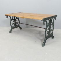 A slatted pine low table / bench with painted cast iron ends. 88x40x44cm.