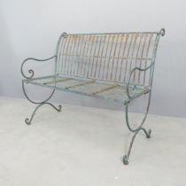 A painted and weathered iron garden bench. 103x85x60cm. Seat and back are hinged for folding, but