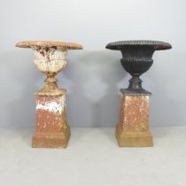 A large and impressive pair of early Victorian cast iron fluted urns on pedestals. 60x95cm.