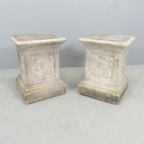 A pair of square weathered stone garden plinths with Art Nouveau decoration, in the manner of LEFCO.