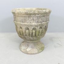 A weathered concrete two-section garden urn on stand. 40x44cm.