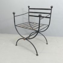 A vintage neoclassical style painted iron curule chair in the manner of Maison Jansen.
