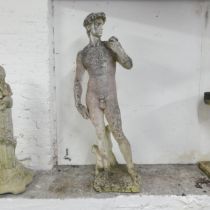 A weathered stone garden sculpture, after Michelangelo's David. Height 120cm. Some damage to