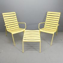 A pair of modern painted metal garden loungers, with matching table / footstool.