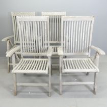 BRAMBLECREST - A set of four weathered teak folding and reclining garden chairs. With maker's