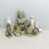 A weathered concrete otter ornament, another concrete rabbit ornament, and an asoortment of