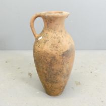 A terracotta olive oil jar. Height 50cm. Marked Terracino S.D.P.