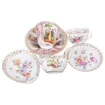 A Dresden cup and saucer, with panels of painted figures, another with floral decoration, and a
