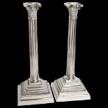 An impressive pair of silver plated Corinthian column candlesticks, raised on stepped plinth