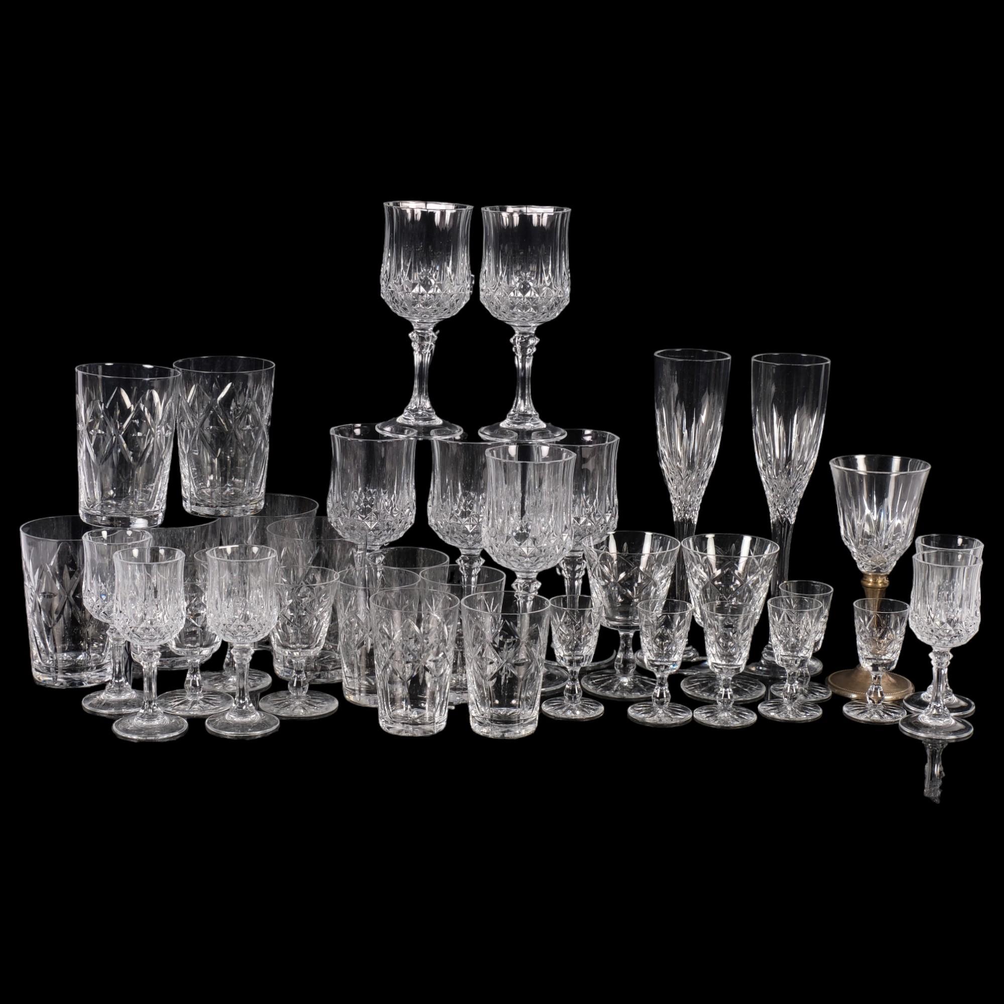 A large selection of crystal glassware, including 2 Stuart Crystal Champagne flutes, a quantity of
