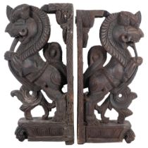 A pair of Eastern stained wood carvings of mythical beasts (Simha Vyala), H44cm