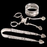 A pair of silver sugar nips, a pair of engraved and pierced silver sugar tongs, and an embossed