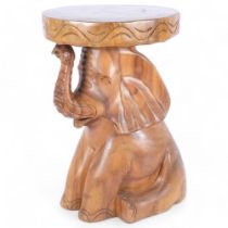 A teak occasional table or stool, modelled as a seated baby elephant, H45cm