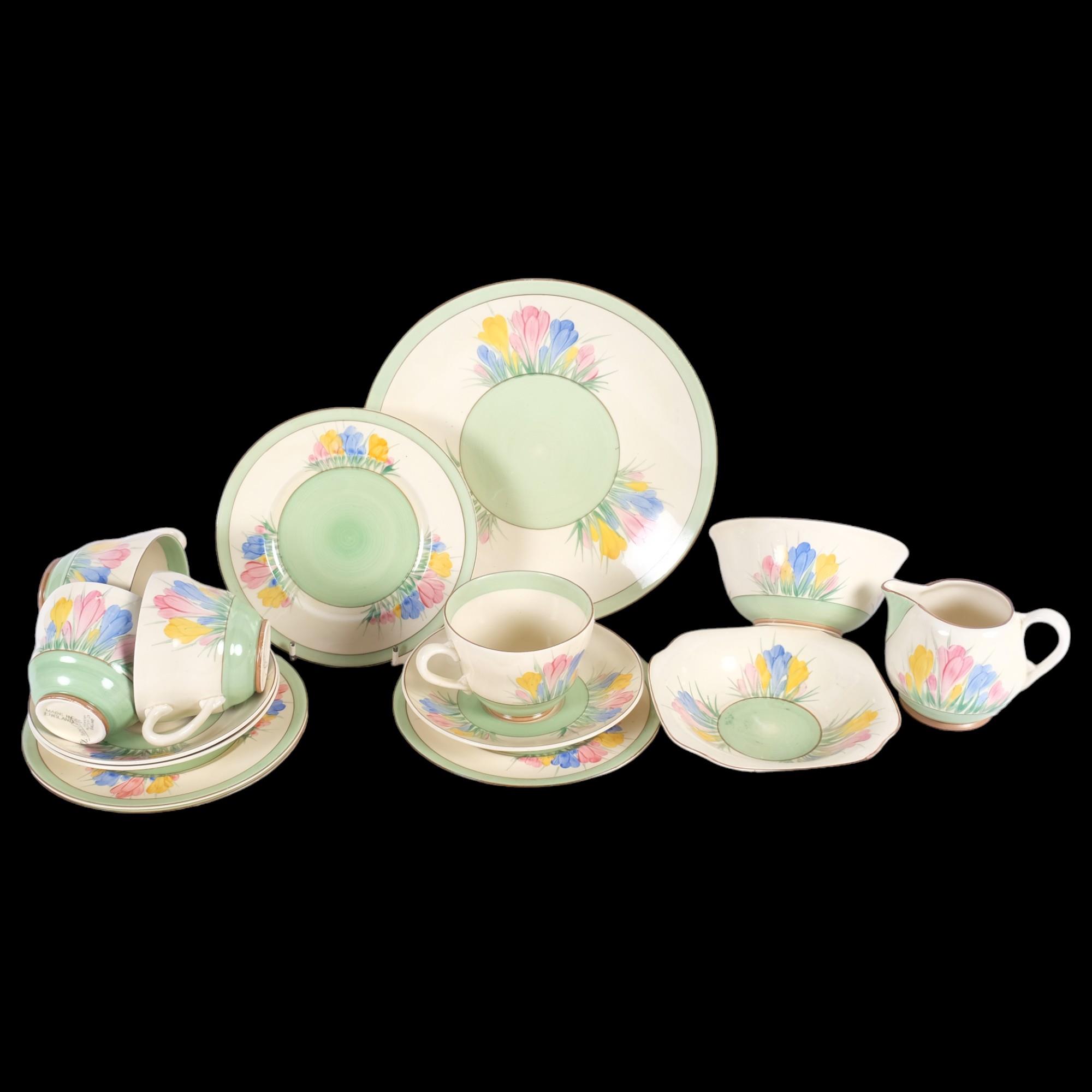 A Clarice Cliff Crocus pattern tea set, comprising 4 cups, 3 saucers, 5 plates, jug and bowl, and