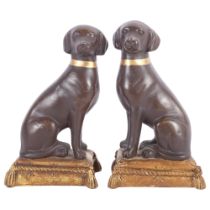 A pair of composition chocolate Labradors on cushions, H20cm