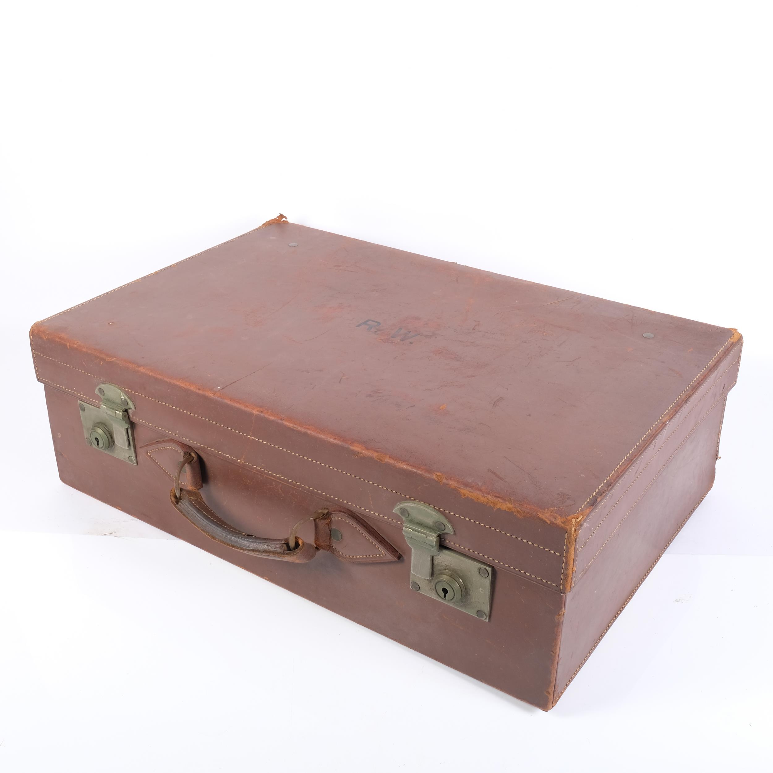 An early 20th century leather-covered gentleman's travelling vanity suitcase, the lid opening to - Image 2 of 2