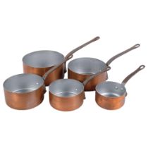 A graduated set of 5 copper saucepans with iron handles, largest 20cm diameter