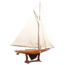 A large scratch-built wooden pond yacht, with associated stand, including mast, 186cm x 235cm x 34cm