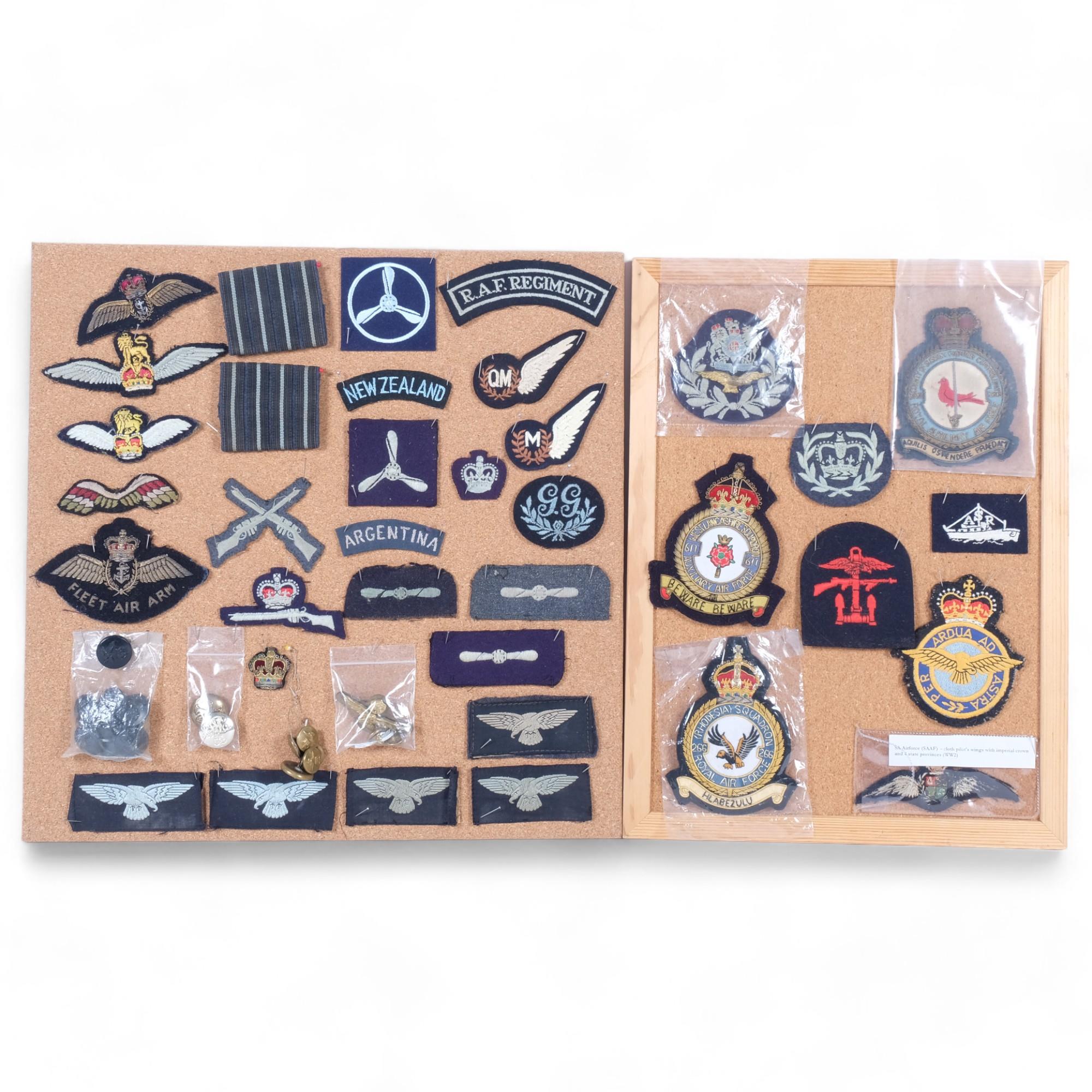 A collection of cloth military badges, including New Zealand, Argentina, RAF, etc, and various