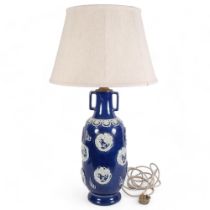 An Oriental ceramic blue and white table lamp, with embossed decoration and shade, H82cm