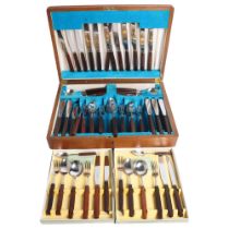 THOMAS W CORK & SON - a canteen of stainless steel cutlery with stained hardwood handles, cased