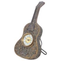 Vintage miniature clock set in a guitar design frame, with pierced and gilt-metal scrolled floral