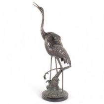 A pair of verdigris bronze cranes on naturalistic base and metal stand, H75cm, base width 20cm