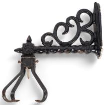 A 19th century painted cast-iron wall bracket of scrolled design, L38cm, with separate lamp holder