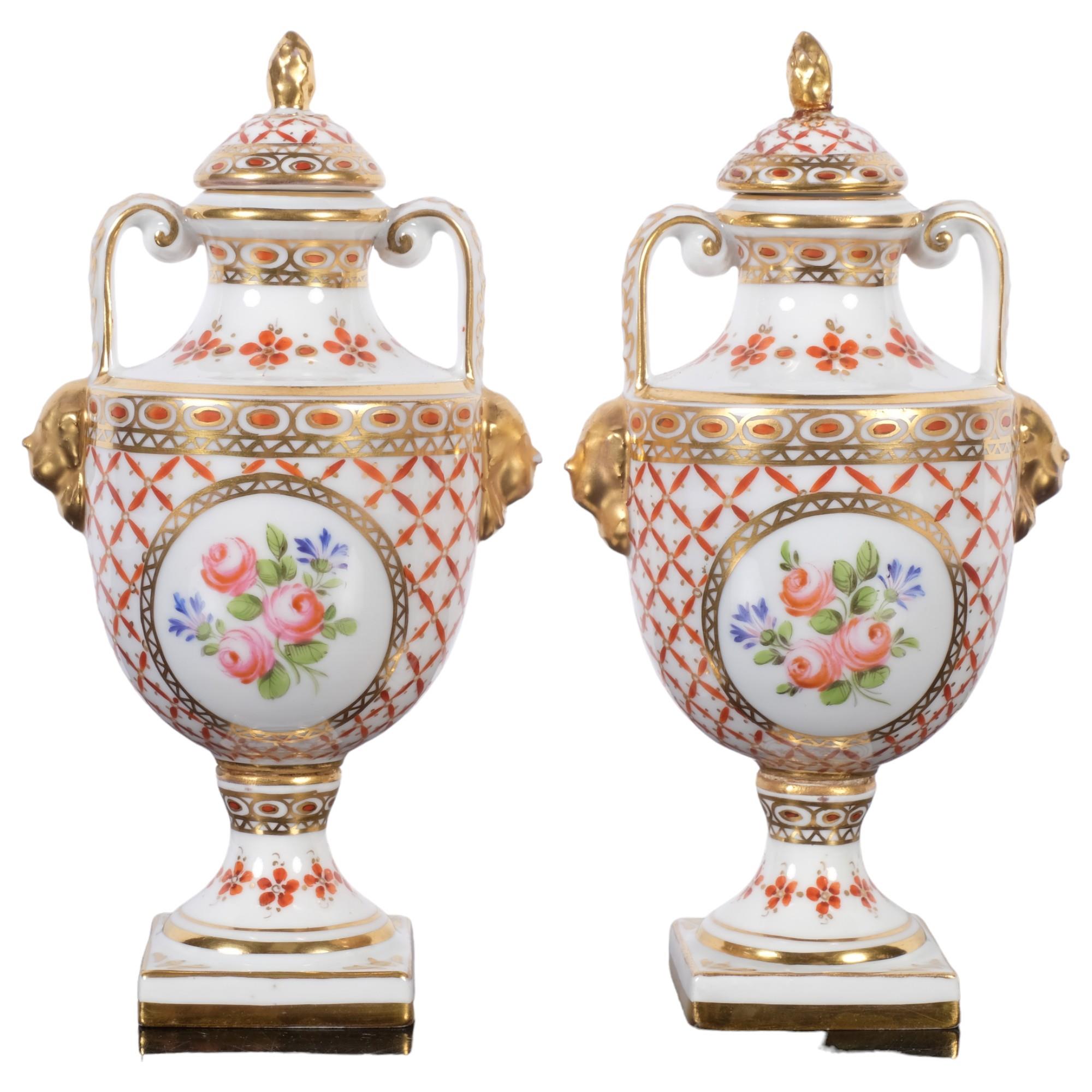 A pair of Antique Sevres porcelain urns and covers, H16.5cm, with impressed mark to the underside