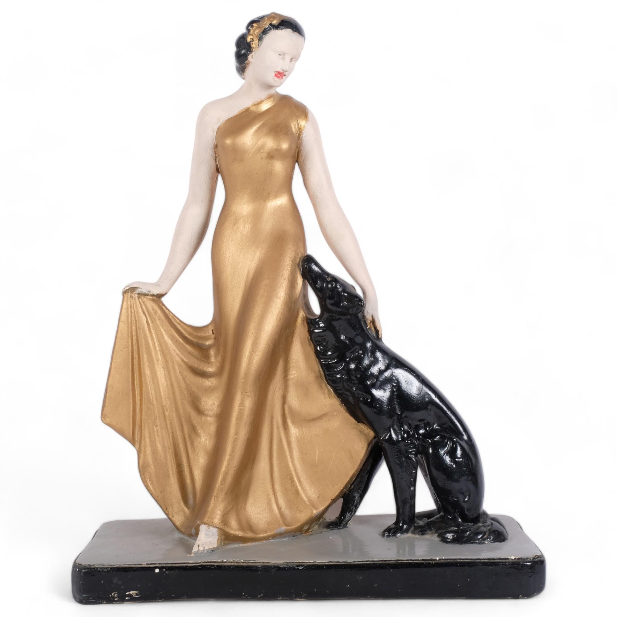 A French Art Deco style plaster sculpture of a female figure in ball gown dress, flanked by dog, H