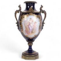 A French blue ground porcelain urn, with hand painted and gilded panels, and gilt-bronze handles and