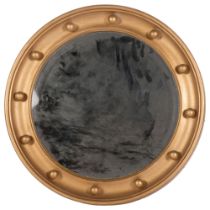 An early 20th century circular giltwood bevel-edge wall mirror, diameter 40cm, trademark label The