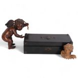Antique ebonised box with embossed cartouche to the lid, 27.5cm, a carved wood cherub figure, and