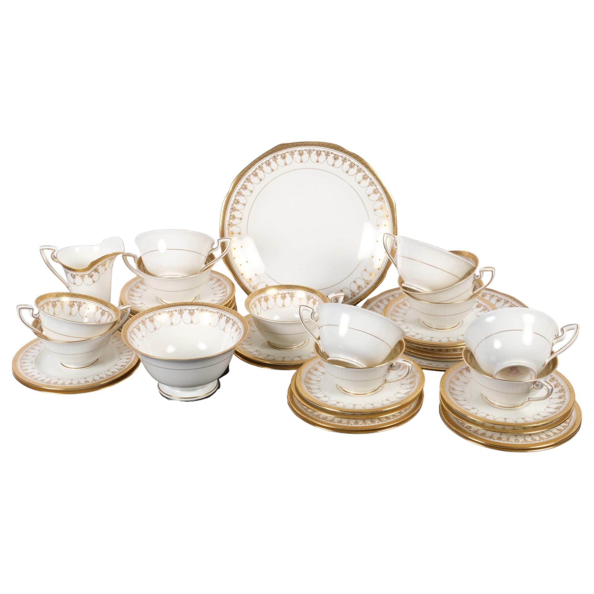 Royal Worcester tea service for 12 people, with gilded swag decoration, including 2 cake plates, jug