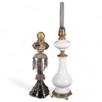 An Art Nouveau brass and white ceramic oil lamp, H80cm, and a cut-glass oil lamp with lustre drops