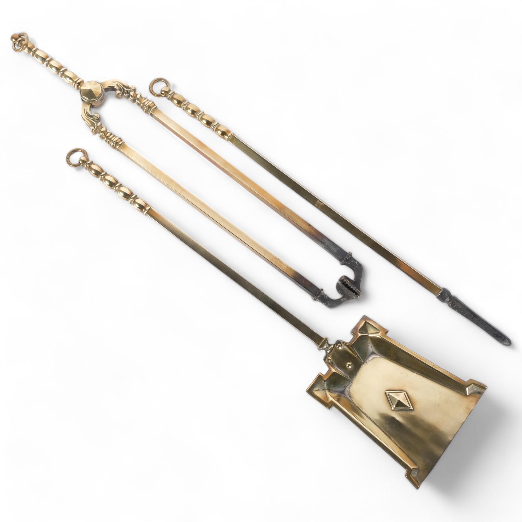 A 3-piece Arts and Crafts brass companion set, longest piece 57cm