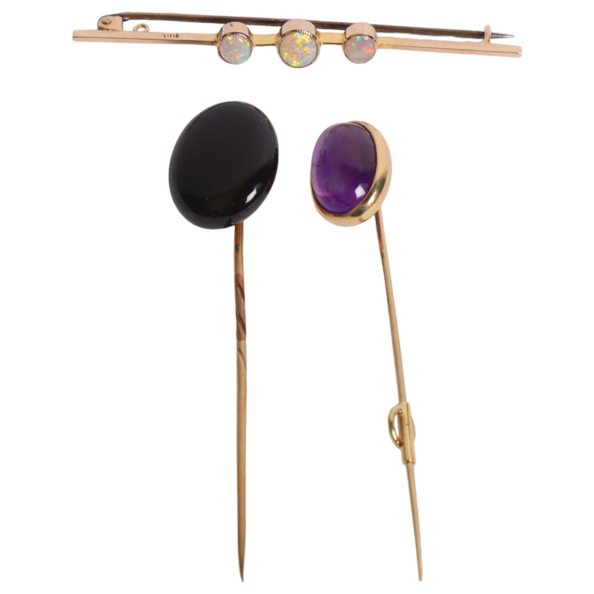 A group of gold jewellery, including a 9ct gold and opal set bar brooch, an 18ct gold and cabochon