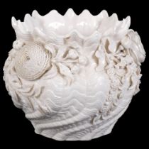 A Belleek porcelain jardiniere, encrusted with flowers and leaves, with black back stamp, height