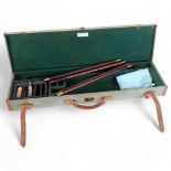 A rectangular hard-bodied gun case, by Brady Sporting Goods, including some cleaning brushes,