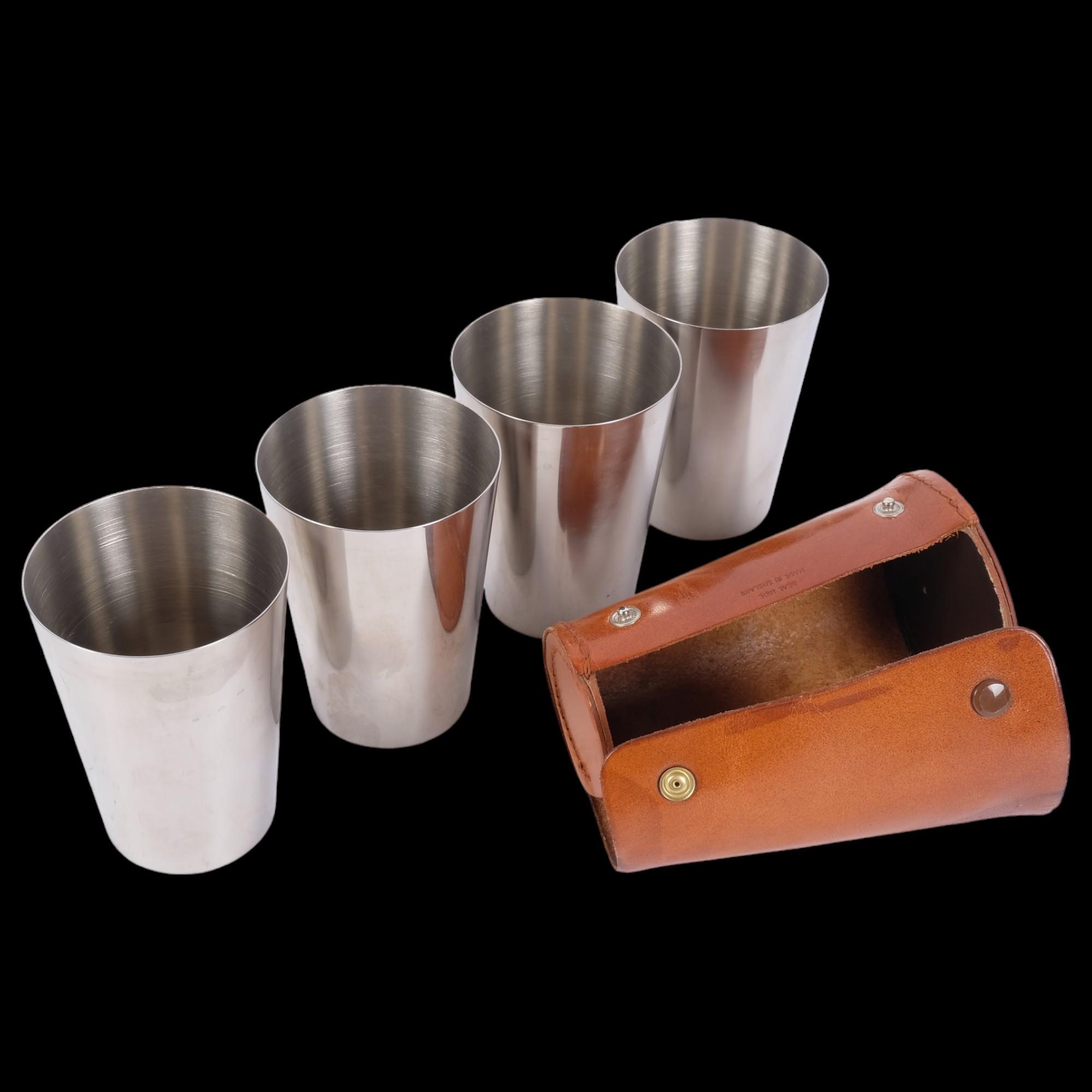 A set of 4 stainless steel stacking beakers, and a leather travelling case