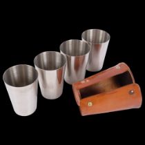 A set of 4 stainless steel stacking beakers, and a leather travelling case