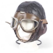 A German Luftwaffe leather sheepskin-lined flying helmet, and a pair of goggles