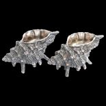 A pair of heavy cast silver plated conch shell design salts