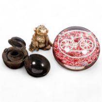 A French glass paperweight, with bicycle motif, a travelling metal inkwell, and a carved staghorn