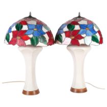 A pair of Art Nouveau style pottery table lamps, with Tiffany style leadlight glass shades with