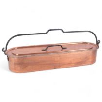 A copper fish kettle with draining tray