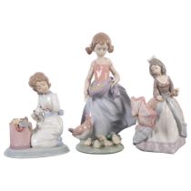 Lladro, girl feeding chickens, H24cm, and a Lladro Christmas Collection girl with kitten