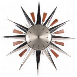 A Metamec starburst wall clock, W60cm, lacking hands There are 3 of the wood sections missing,