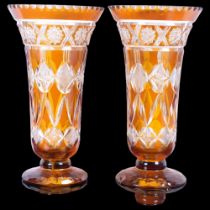 A pair of Vintage amber overlay glass vases, H24cm, foot chip and minor rim chips